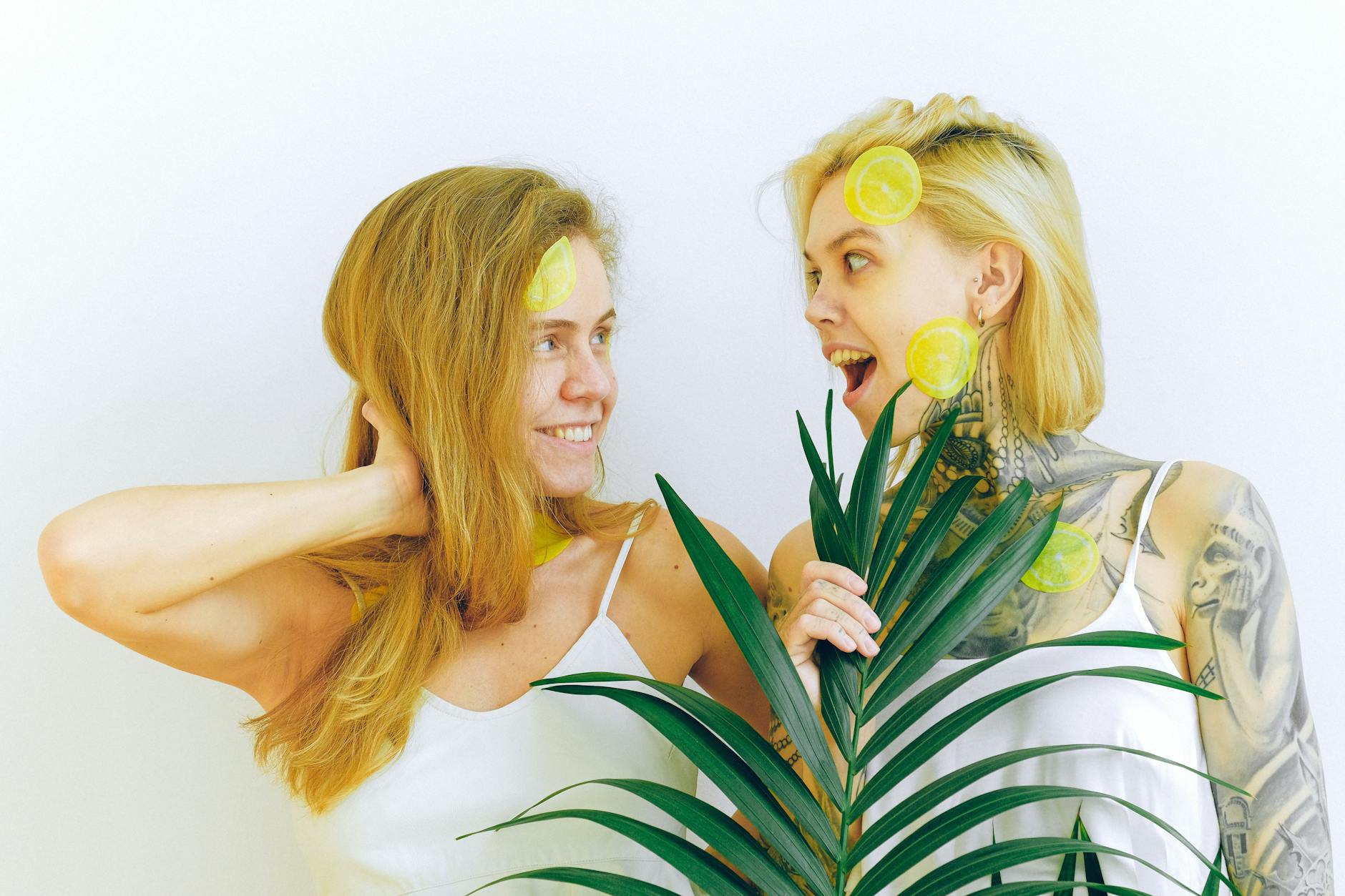 Two people smiling together indoors with fresh fruit, expressing joy and comfort in vulnerability