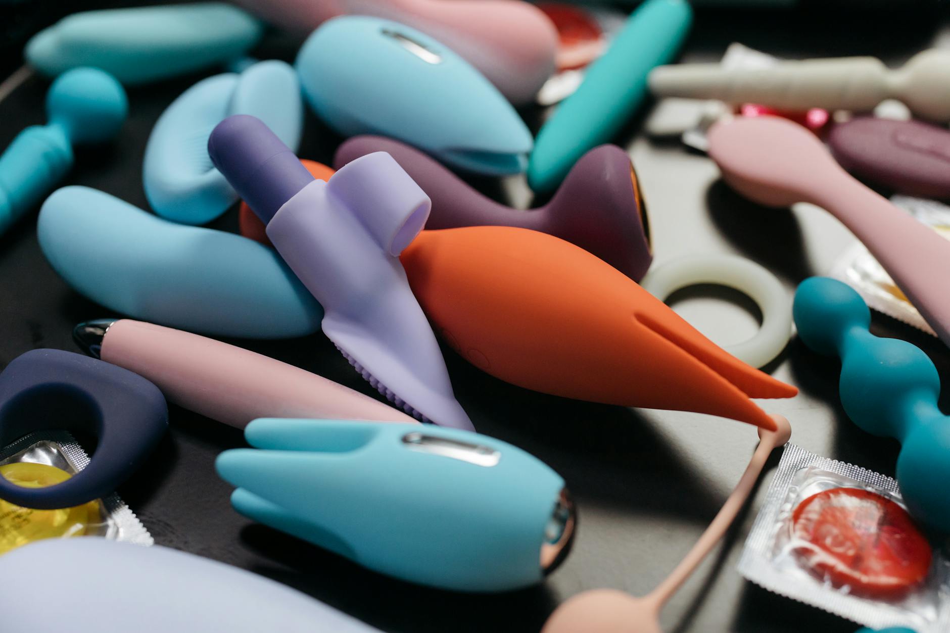 A couple standing together indoors, holding a vibrator, symbolizing modern intimacy and reconnection.