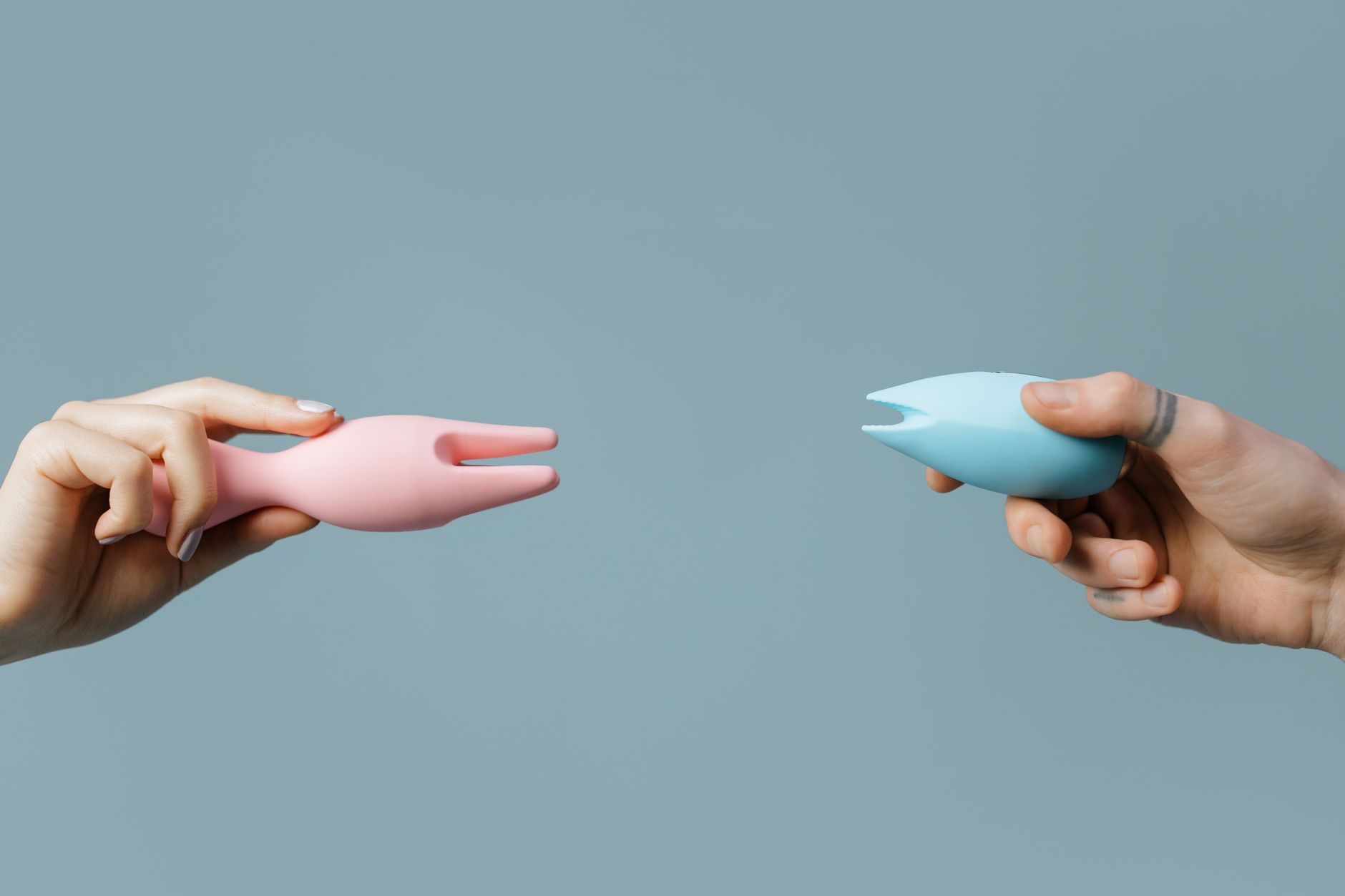 Woman holding clitoral vibrators in a contemplative moment of reconnection