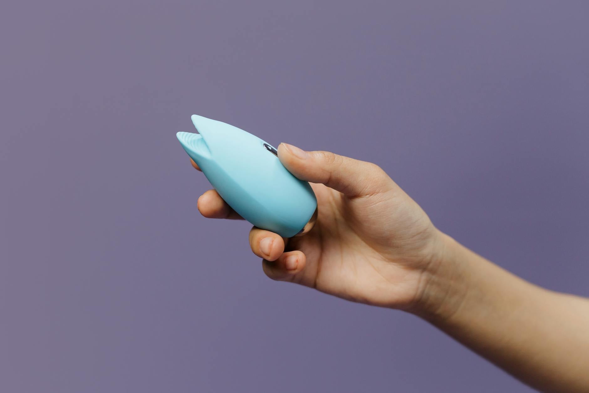 Two colorful vibrators held confidently, symbolizing choice and pleasure agency